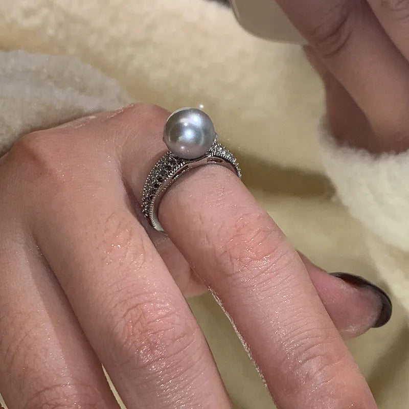 Geometric copper women's ring with adjustable opening and a black pearl detail.