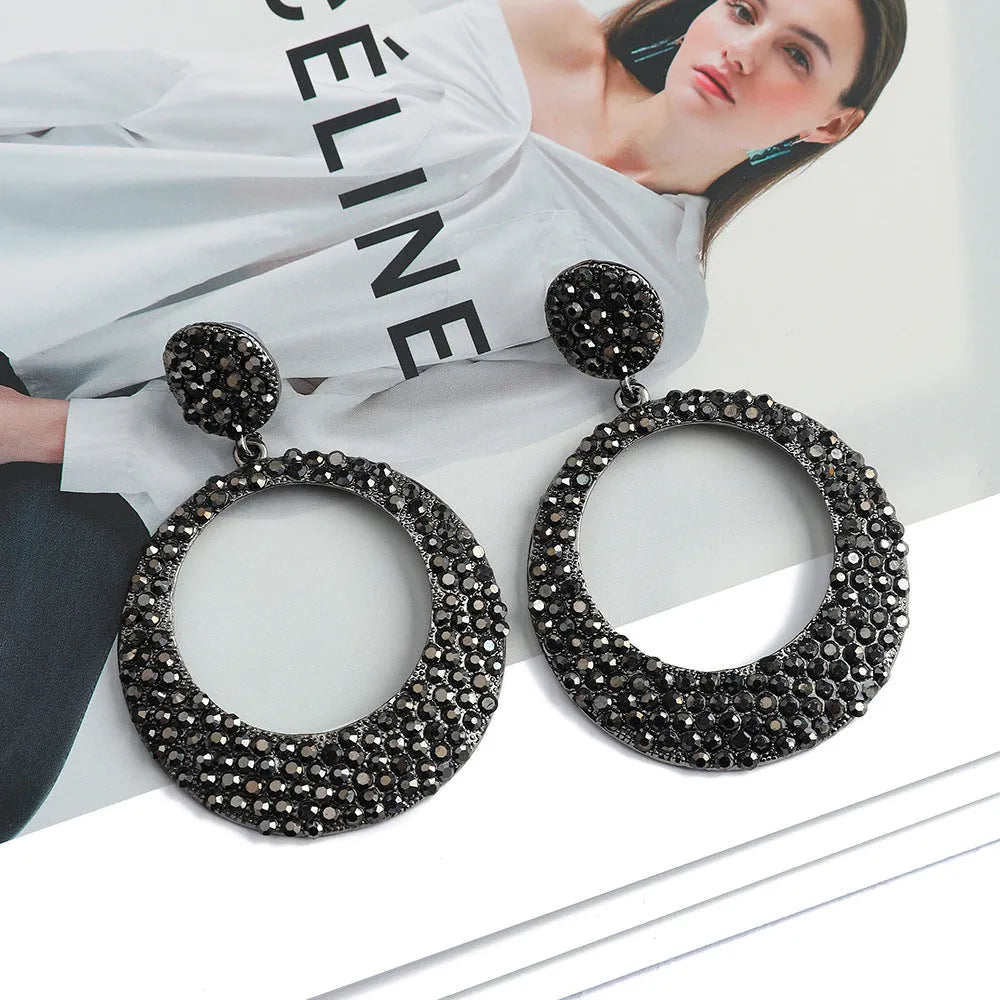 A pair of colourful cartoon style alloy earrings with large round pendant drops for women.