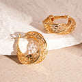 A pair of silver geometric women's stud earrings with a twisted round hollow design.