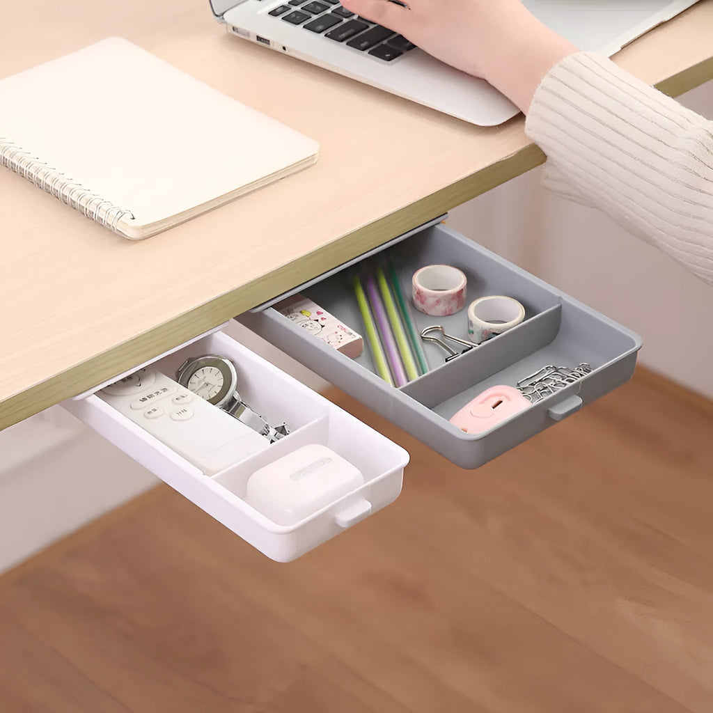 White plastic storage drawer with a cover and internal grid compartment, designed for adhesive mounting under tables