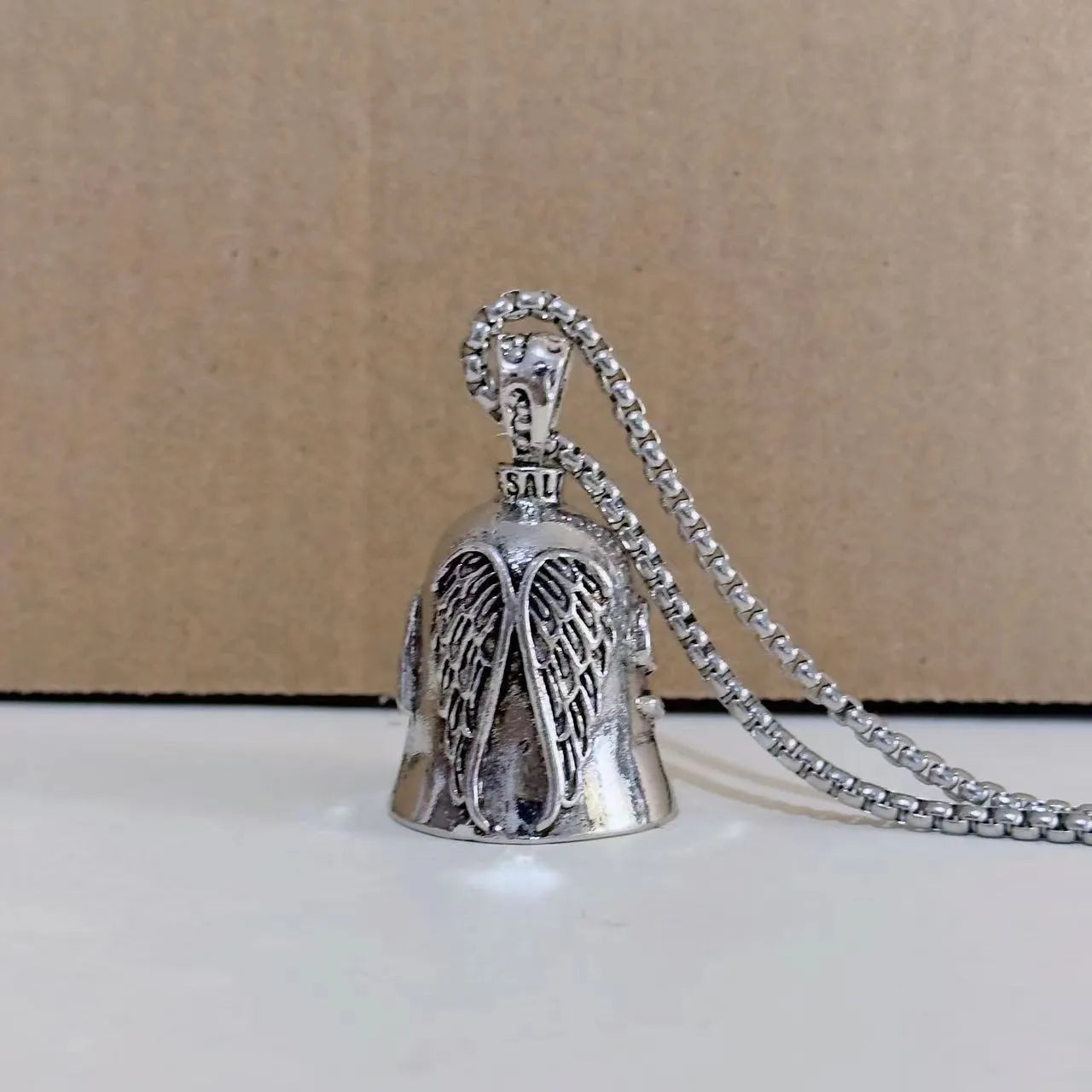 White vintage angel feather design on a zinc alloy necklace and matching keychain.