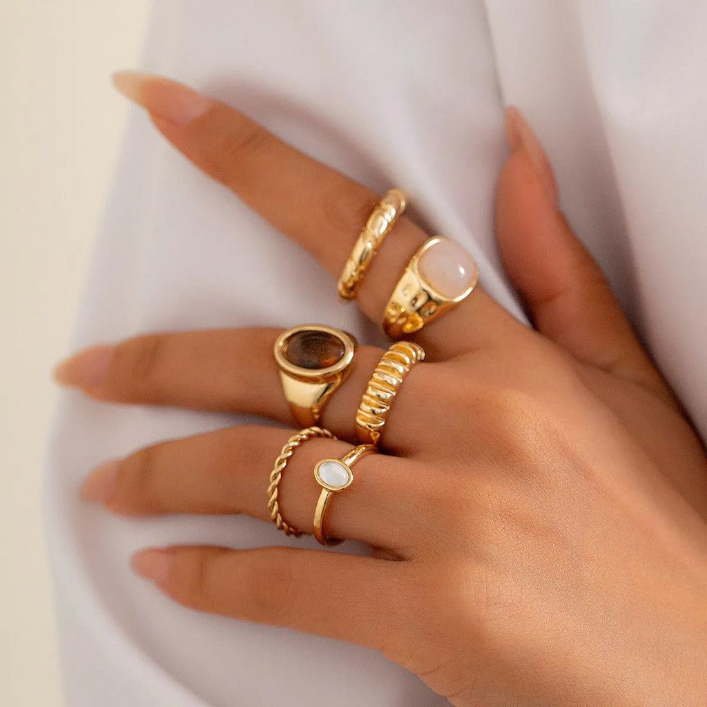 Six irregular geometric alloy rings in light gold electroplated finish arranged as set