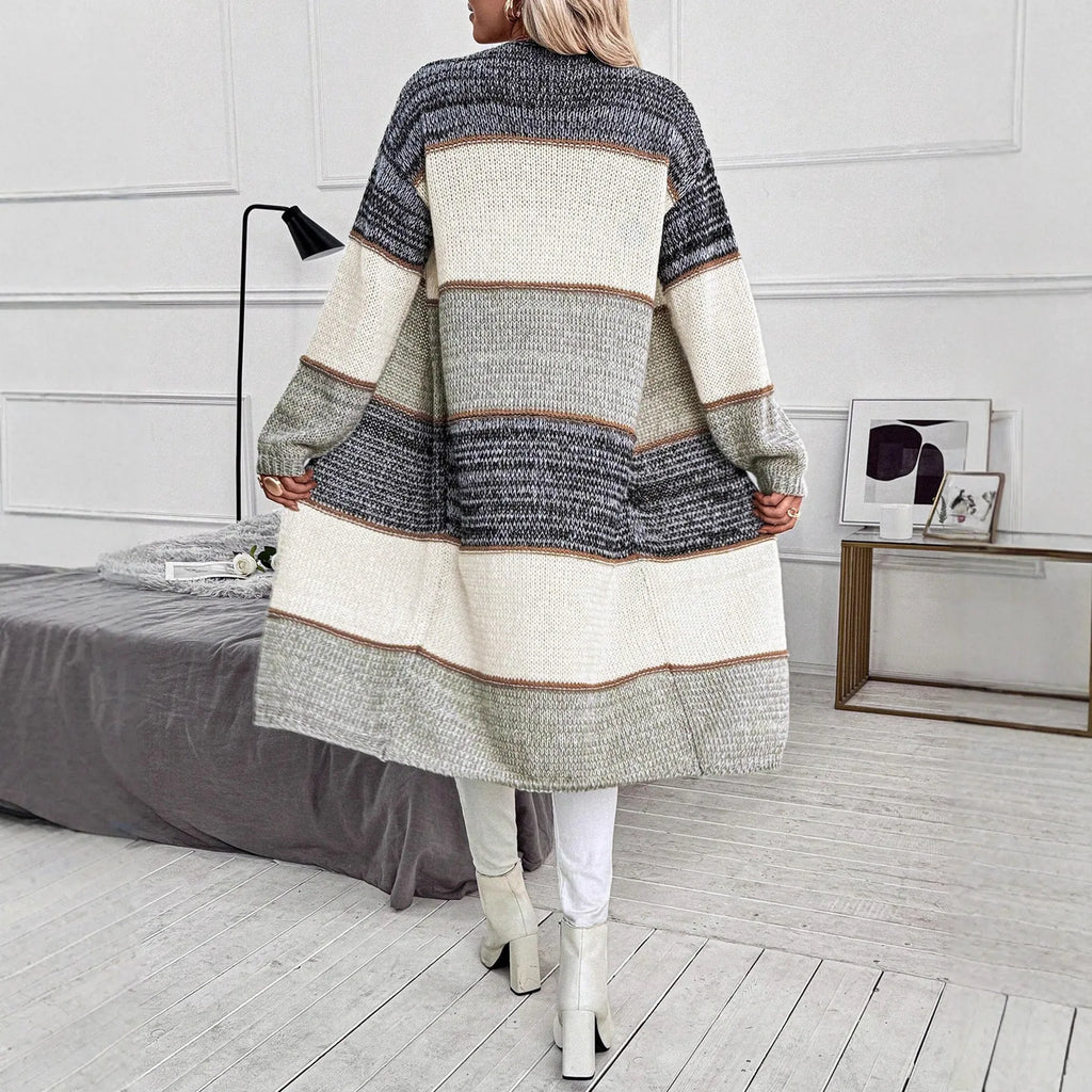 Grey loose fit women's knitted cardigan with long sleeves on a hanger.