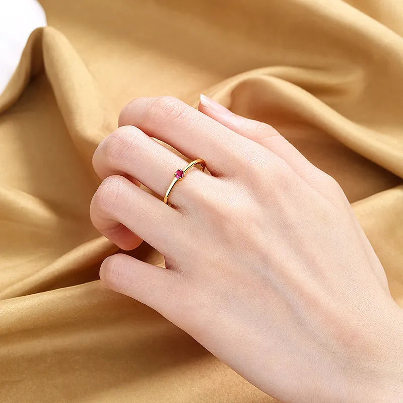 Copper geometric women's ring with a single diamond and fine circle, shown in blue.