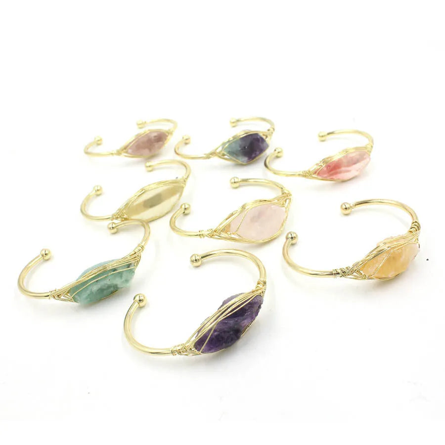 Natural raw gemstone bracelet in amorphous winding shape with simple opening, shown in amethyst crystal colour.