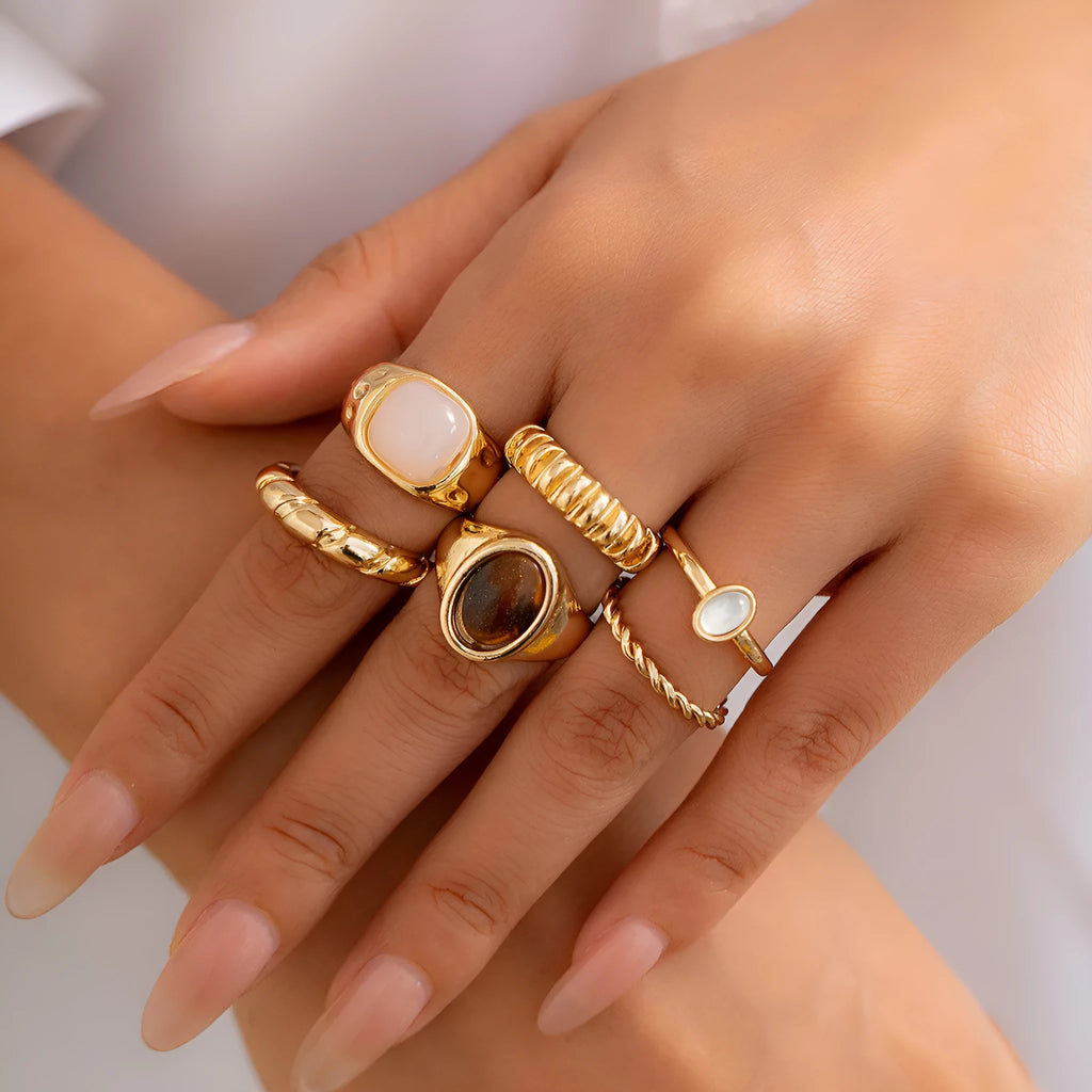 Six irregular geometric alloy rings in light gold electroplated finish arranged as set