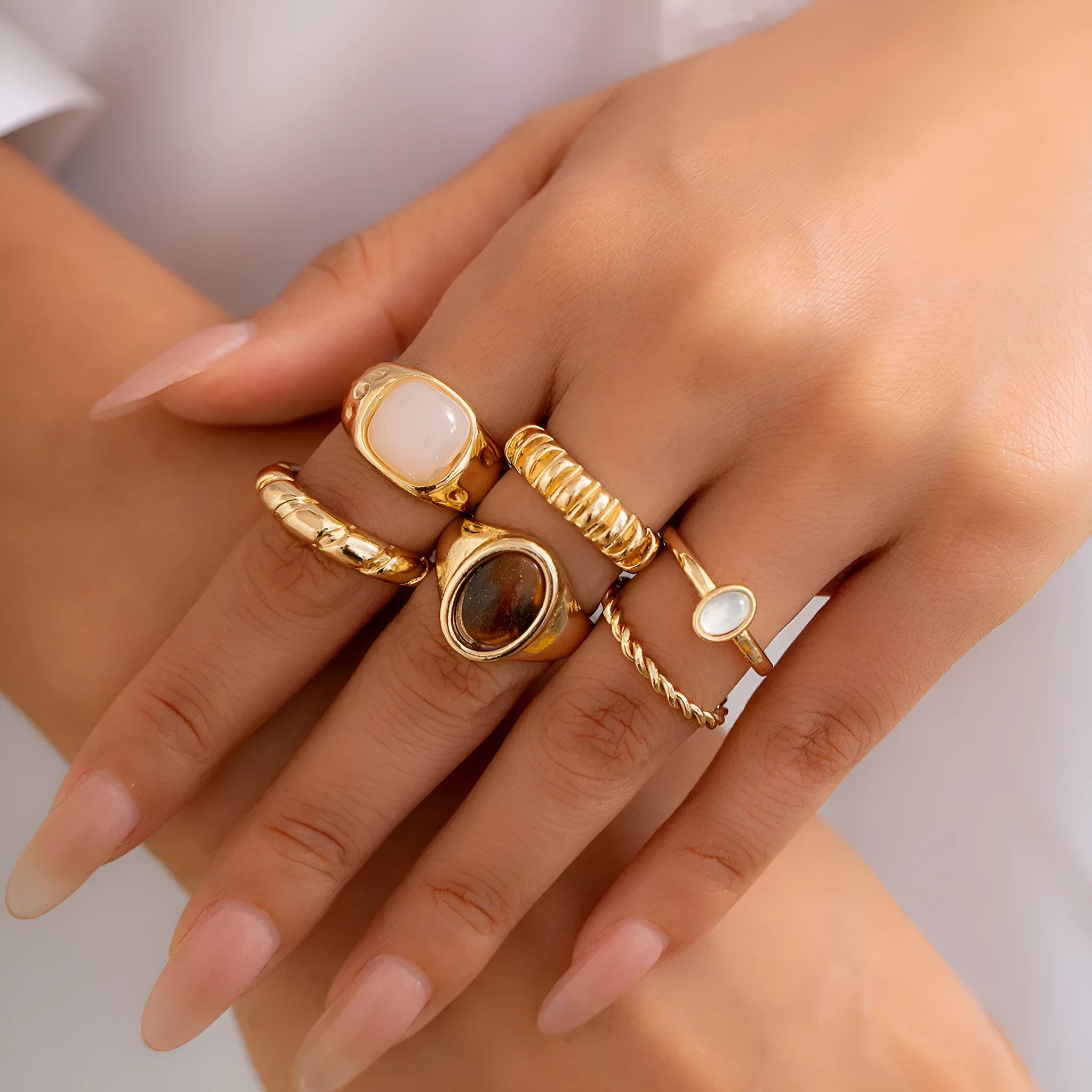 Six irregular geometric alloy rings in light gold electroplated finish arranged as set