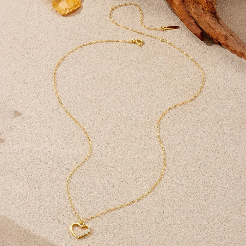 Sterling silver hollow heart pendant necklace on a regular chain, shown in a white gold colour finish.