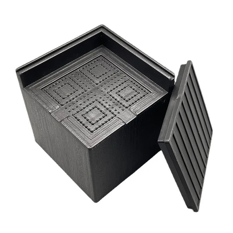 Four black plastic bed foot mats for raising furniture height with modern simple style