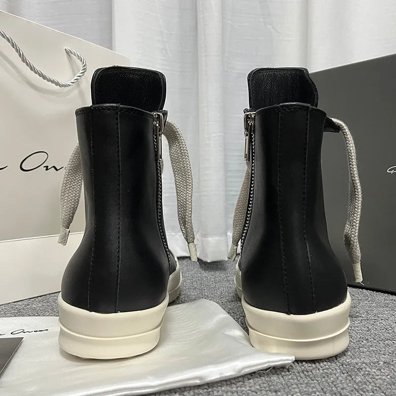 Genuine leather high-top sneakers in black with side zipper and rubber sole.