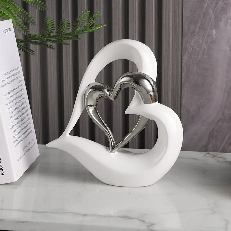 Modern white porcelain heart-shaped geometric ornament in a metallic gold finish.