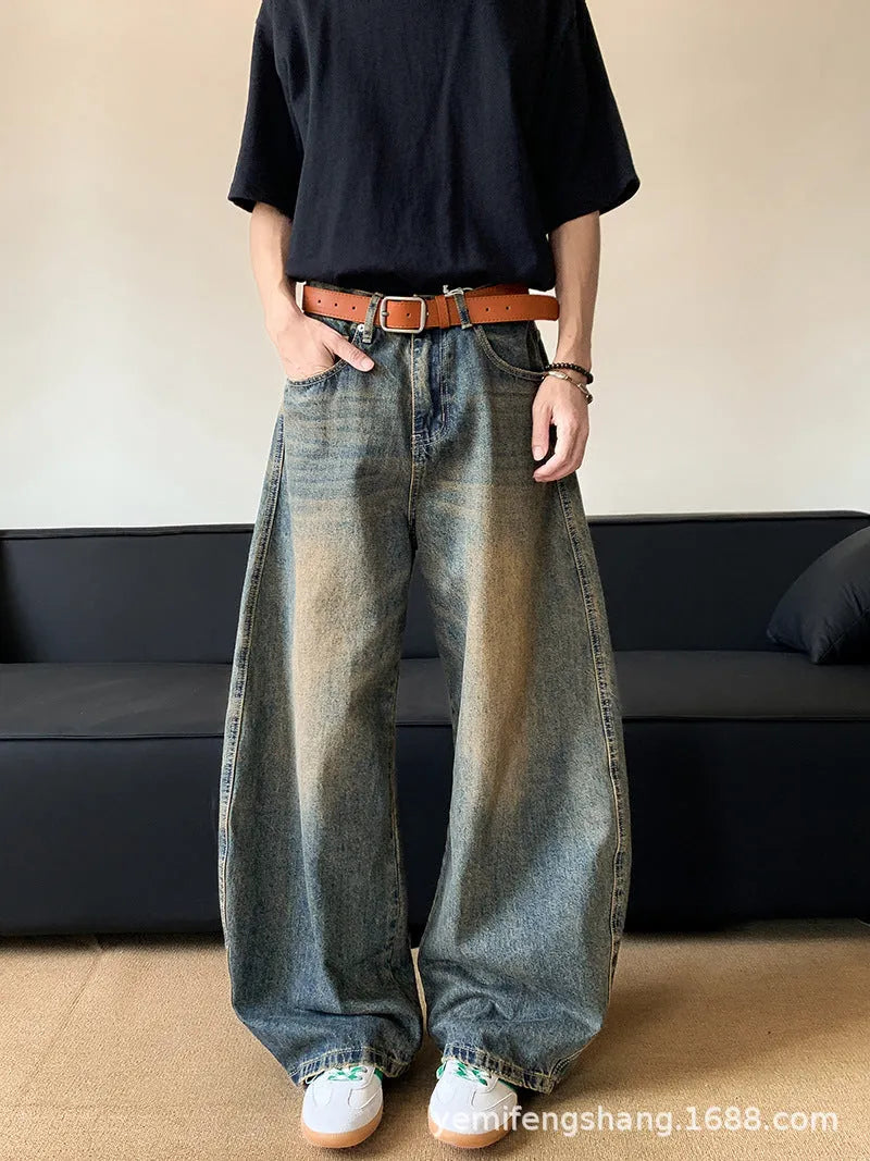 Man wearing retro blue distressed wide-leg denim jeans with a slimming fit and mid waist design.