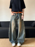 Man wearing retro blue distressed wide-leg denim jeans with a slimming fit and mid waist design.