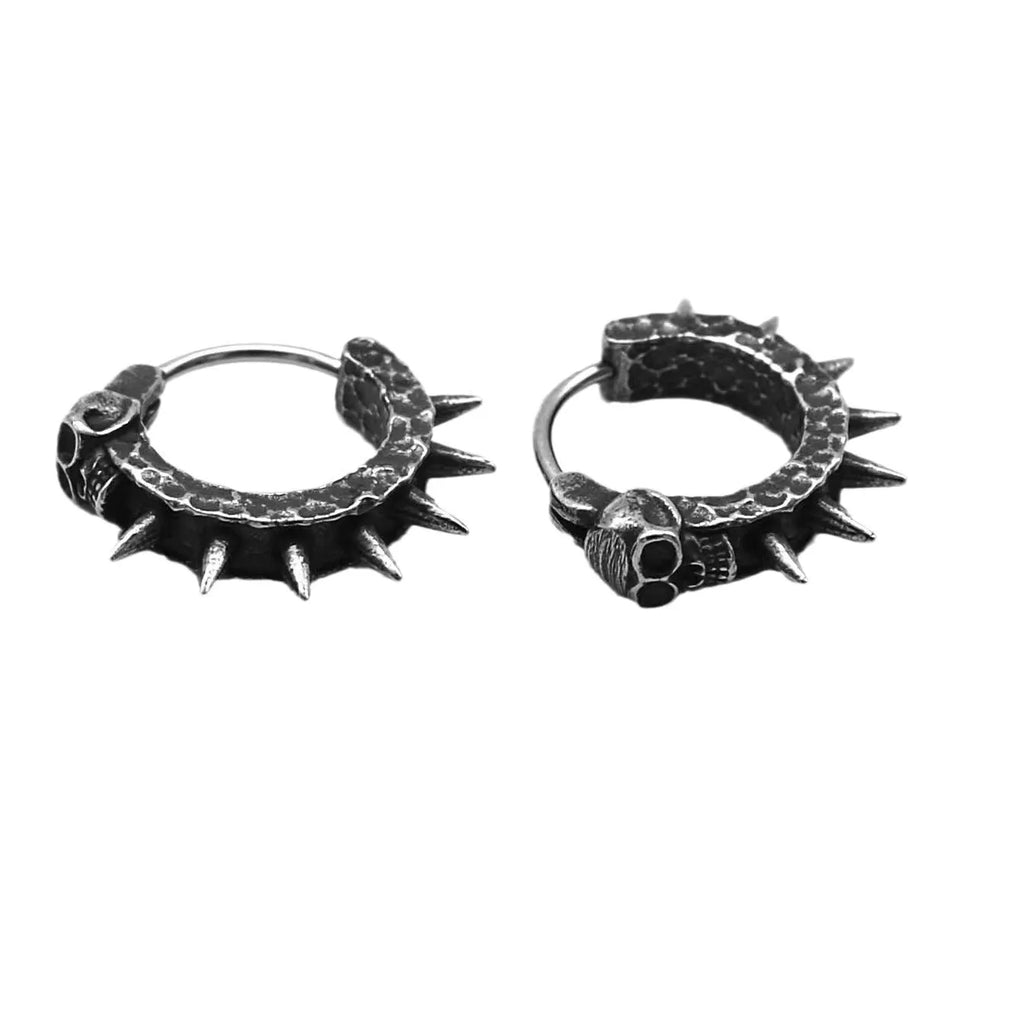 Close-up of black zinc alloy motorcycle-shaped earrings with copper-plated plastic punk details.