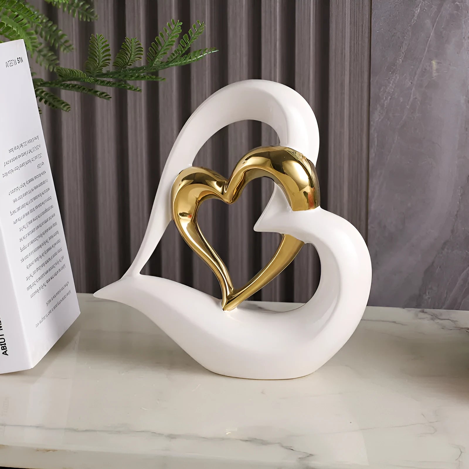 Modern white porcelain heart-shaped geometric ornament in a metallic gold finish.