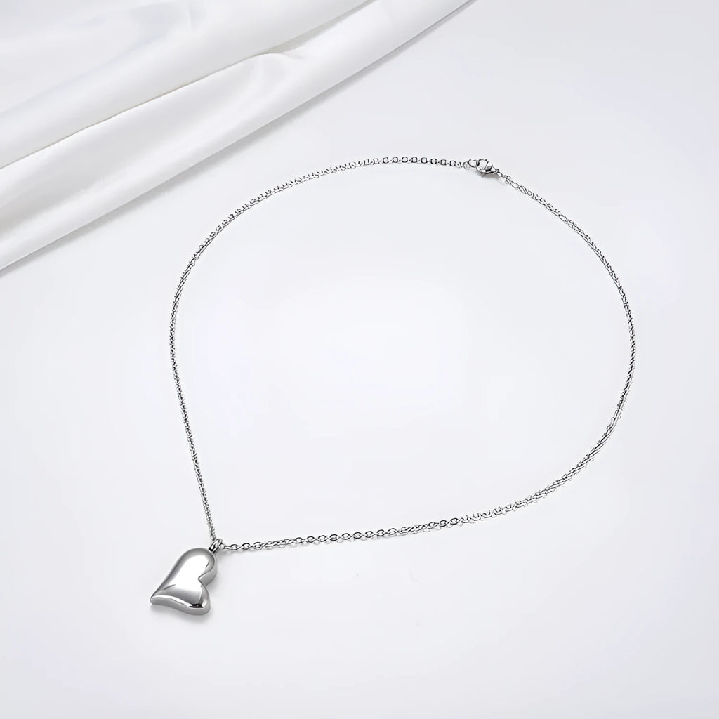 Silver curved peach heart pendant on stainless steel necklace with adjustable chain