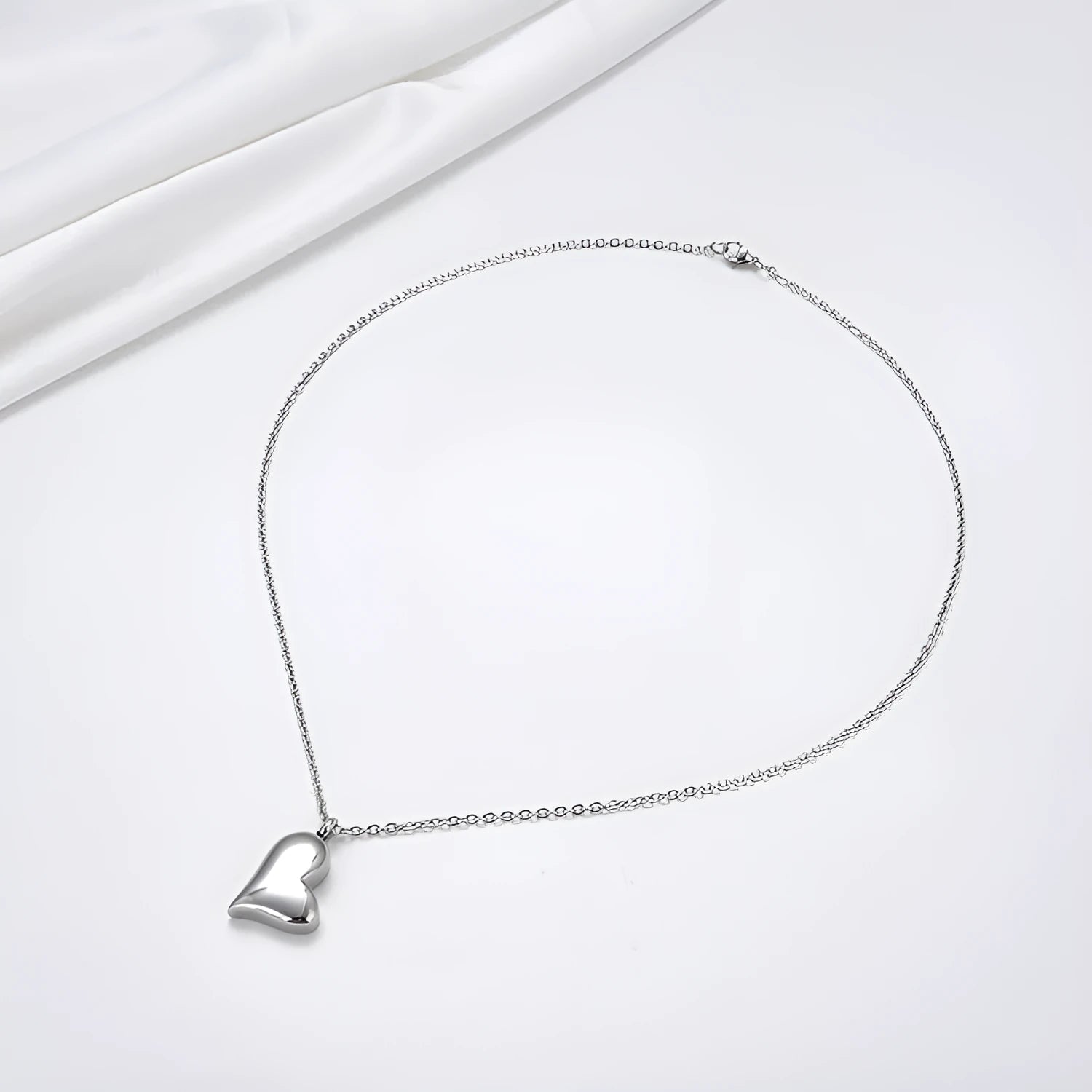 Silver curved peach heart pendant on stainless steel necklace with adjustable chain