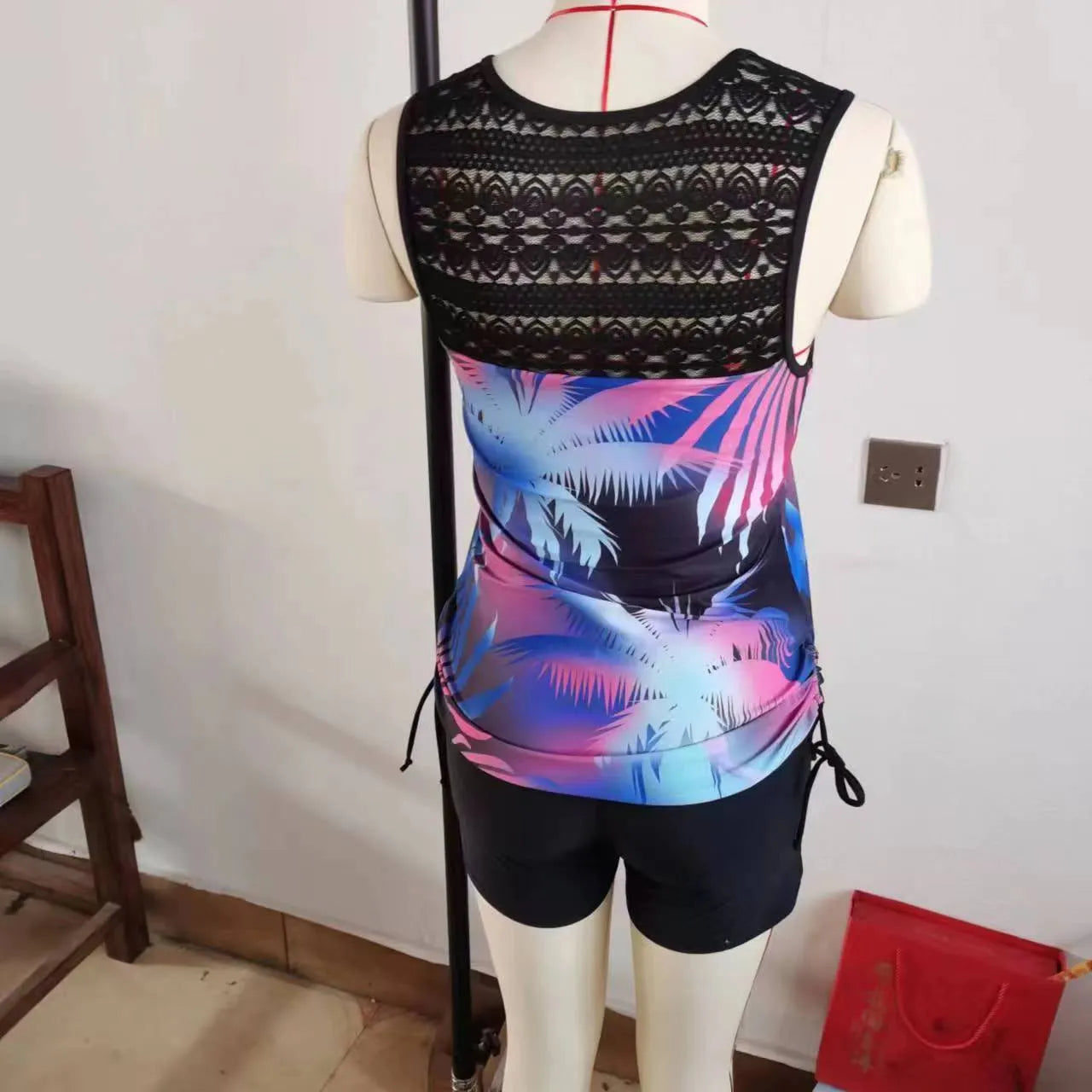 Blue floral lace two-piece women's swimsuit with separate top and shorts.