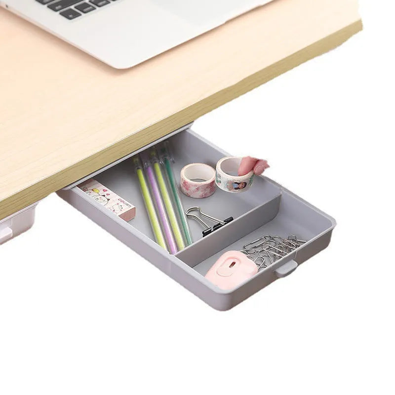 White plastic storage drawer with a cover and internal grid compartment, designed for adhesive mounting under tables
