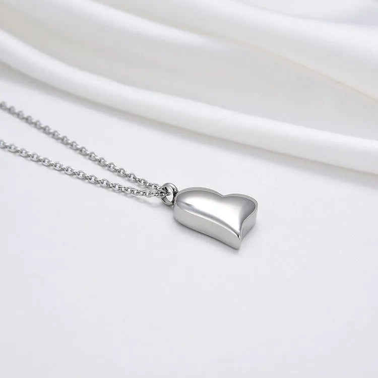 Silver curved peach heart pendant on stainless steel necklace with adjustable chain