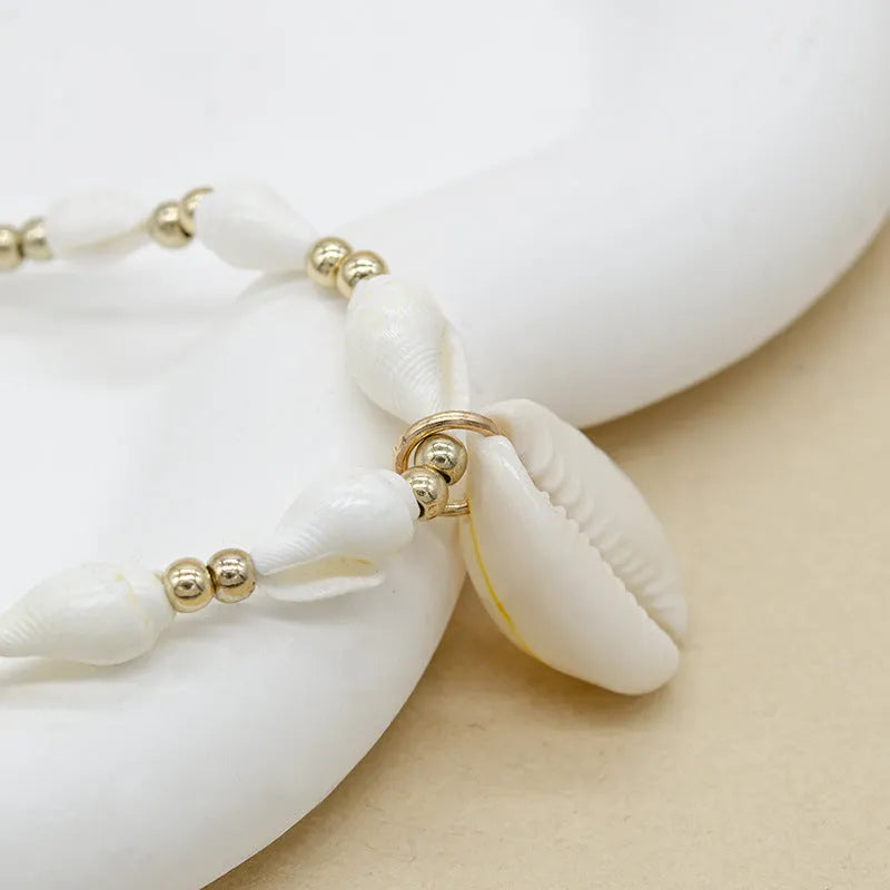 White conch shell mother-of-pearl pendant necklace on a silver electroplated chain for women.