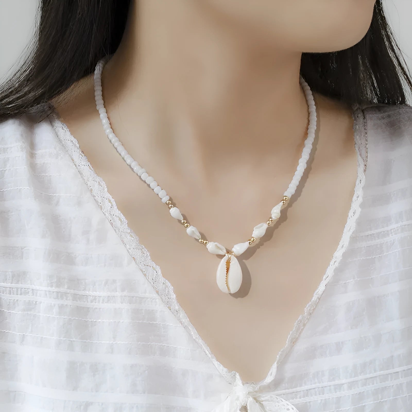 White conch shell mother-of-pearl pendant necklace on a silver electroplated chain for women.