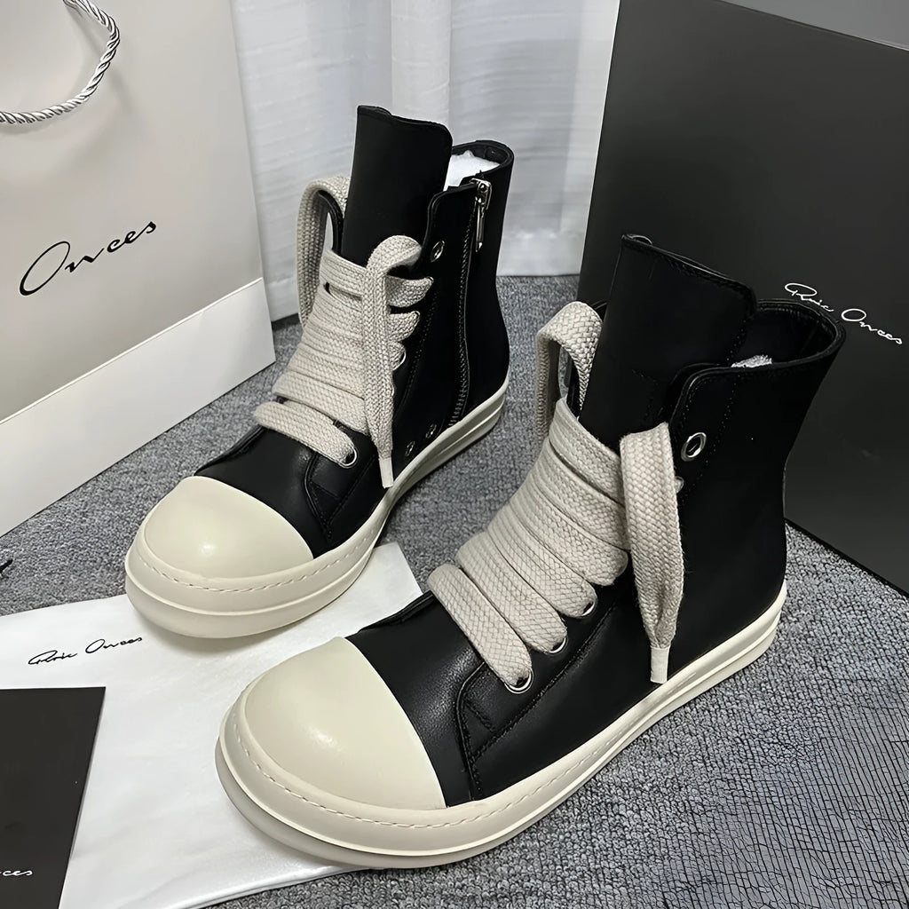 Genuine leather high-top sneakers in black with side zipper and rubber sole.