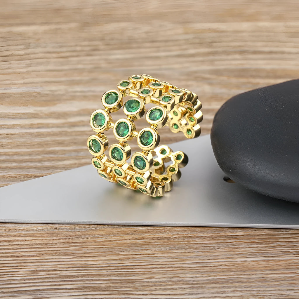 Wide gold-plated copper ring with a large cluster of green zircon stones.