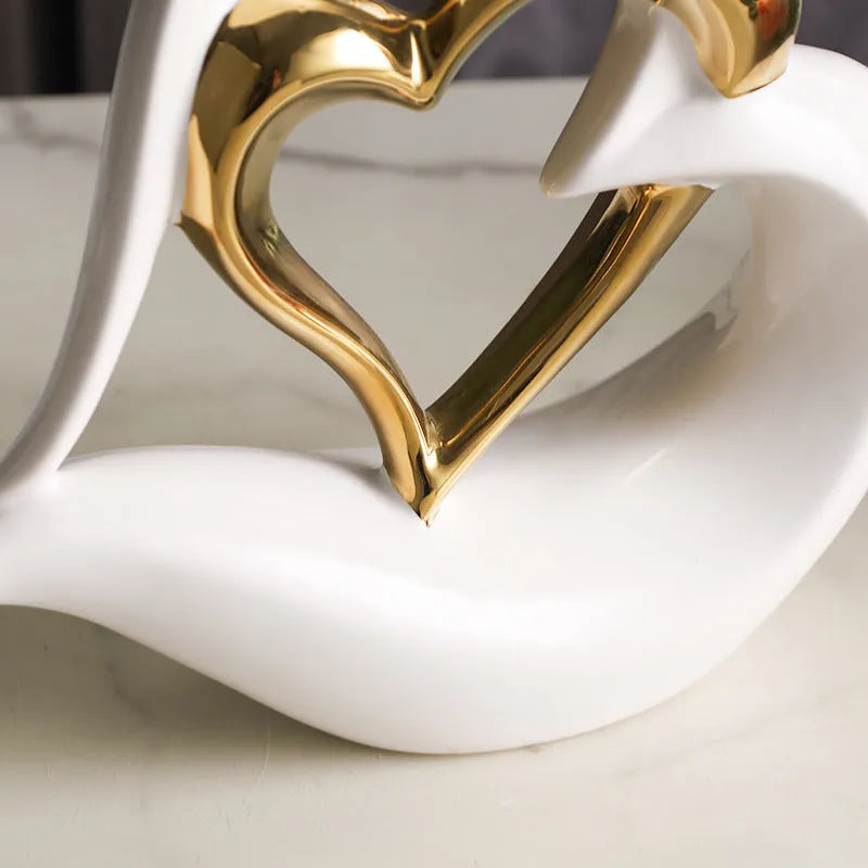 Modern white porcelain heart-shaped geometric ornament in a metallic gold finish.