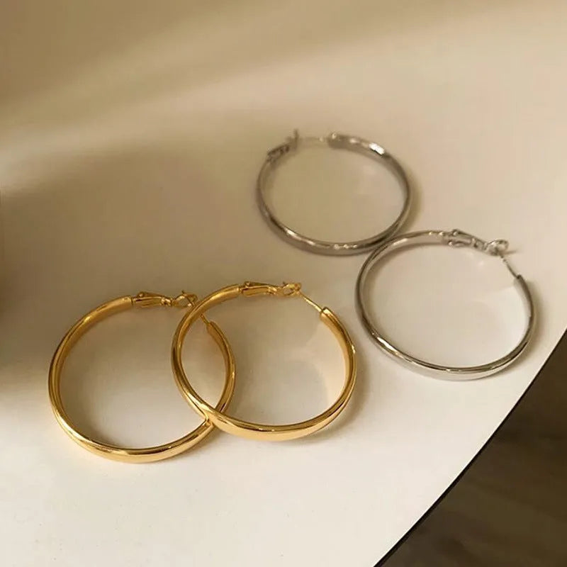 A pair of round gold-coloured metal hoop earrings on a 40mm diameter circle.