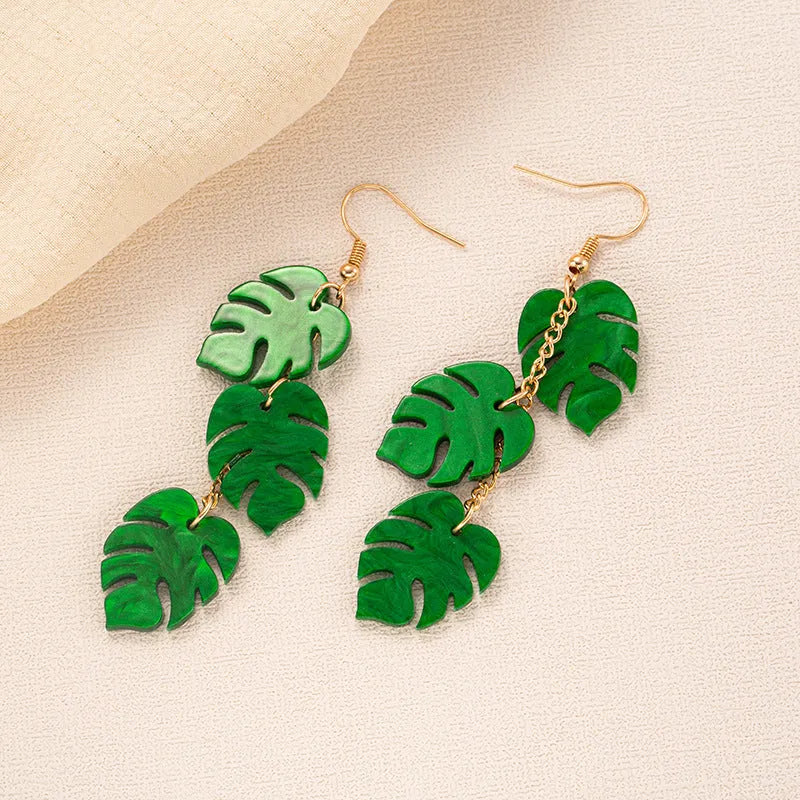 Close-up of acrylic drop earrings with a coconut artocarpus design on alloy hooks, showing one of five colour styles.