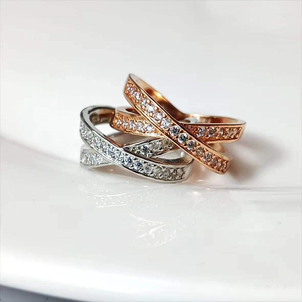 Silver cross ring with micro-inlaid zircon stones and geometric heart design on hand