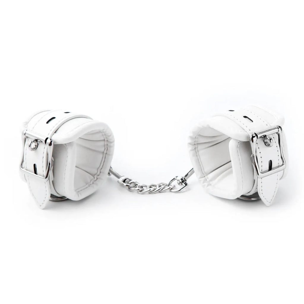 White PU sponge bondage set showing handcuffs, ankle cuffs, and a neck scarf.