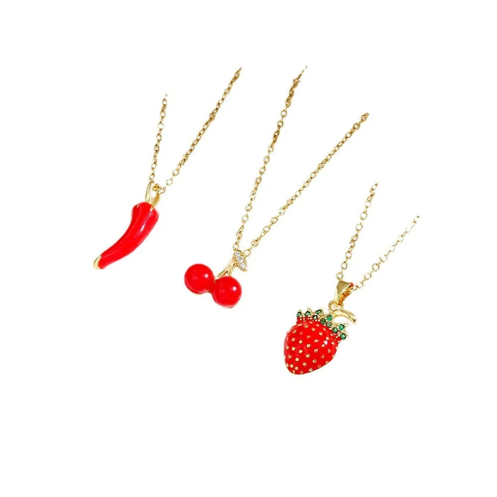 Women's titanium steel necklace with small red cherry, strawberry, and pepper charms on O-ring chain.