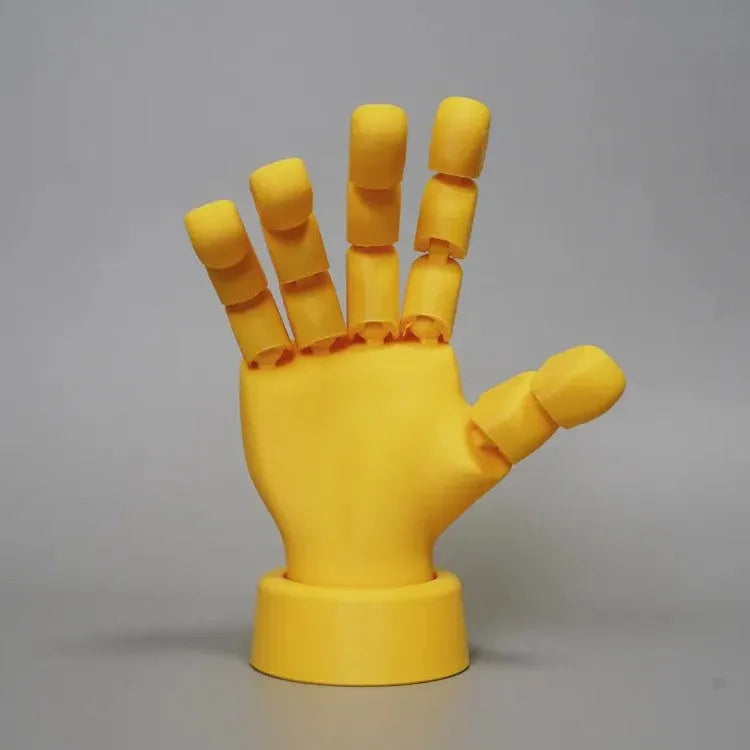 Yellow PLA movable joint hand prop figurine on a white background.