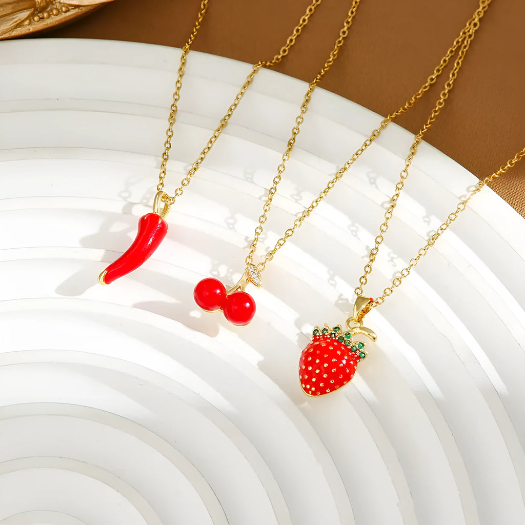 Women's titanium steel necklace with small red cherry, strawberry, and pepper charms on O-ring chain.