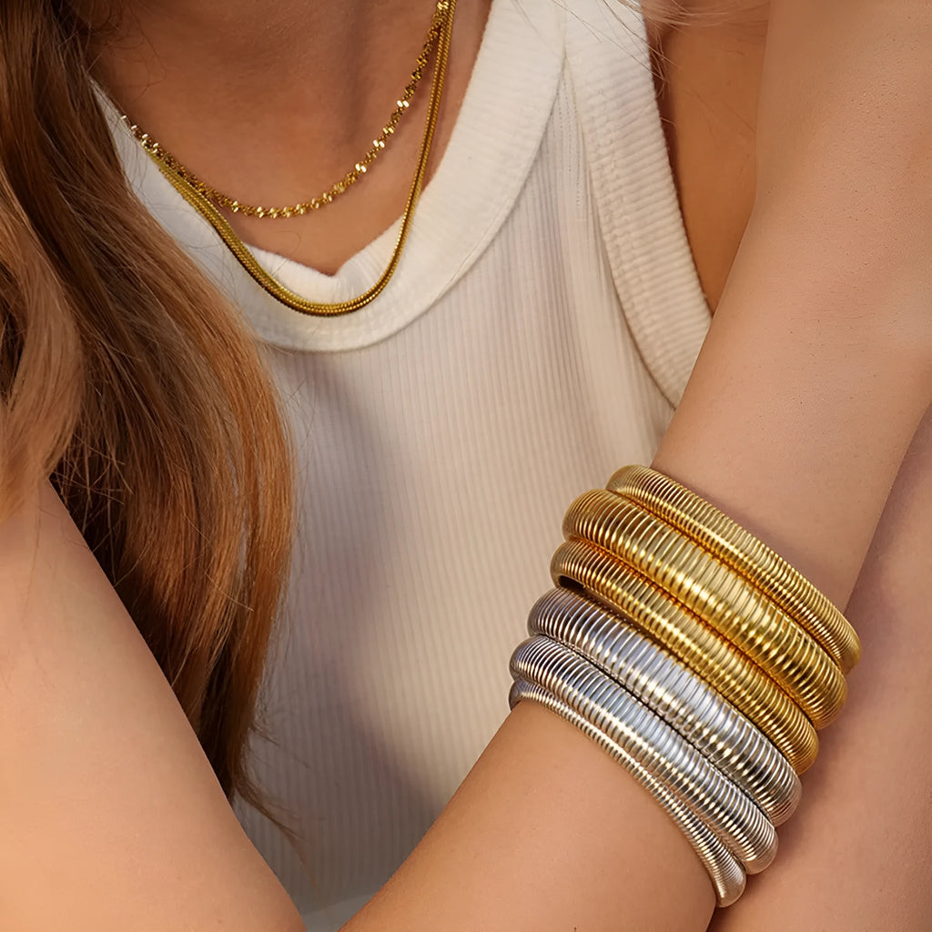 Women's titanium steel bracelet with vertical stripe ring pattern in gold colour
