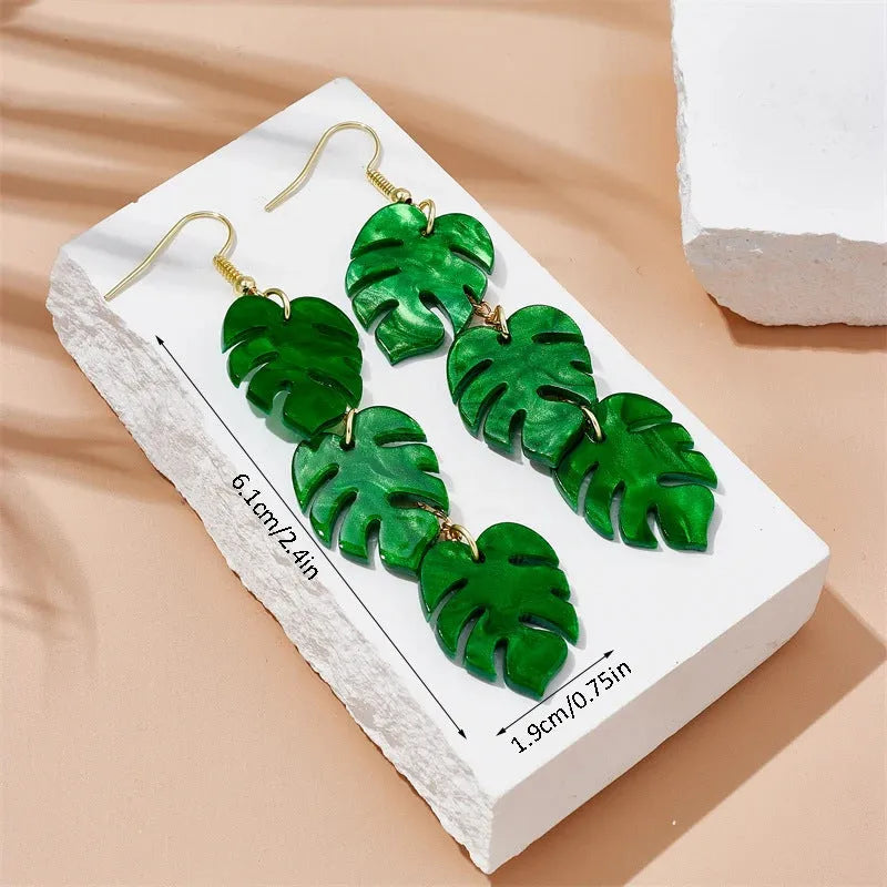 Close-up of acrylic drop earrings with a coconut artocarpus design on alloy hooks, showing one of five colour styles.