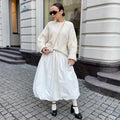 Women's long solid colour cotton skirt in black on a hanger.