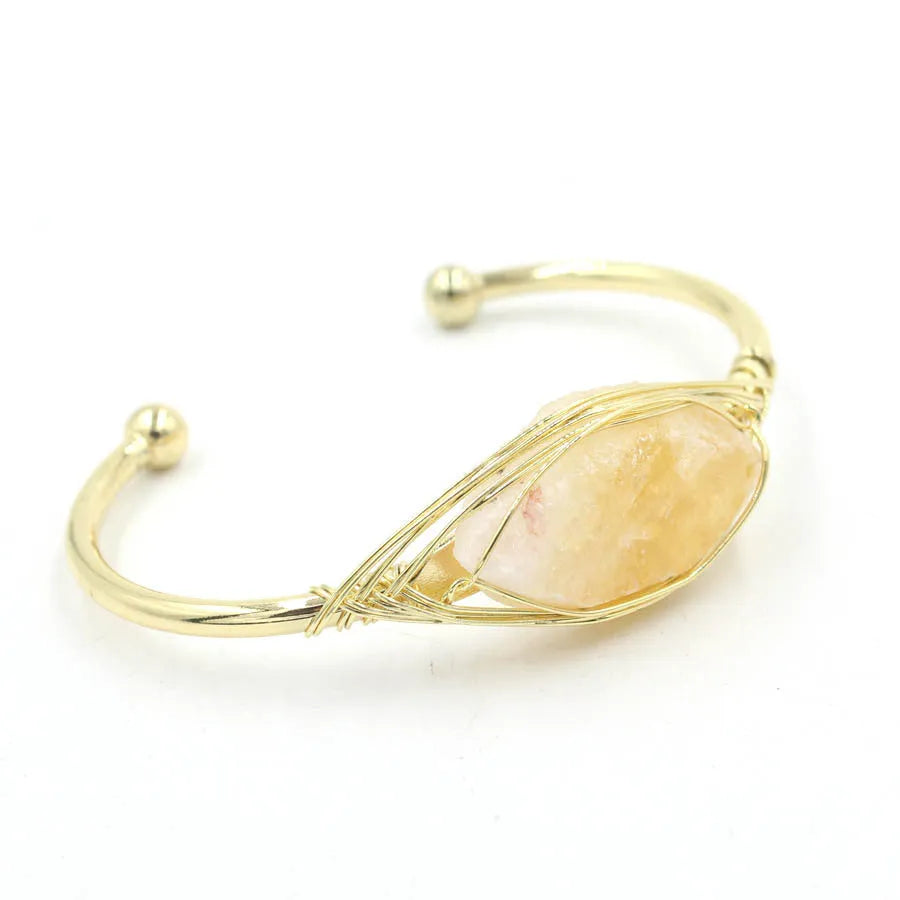 Natural raw gemstone bracelet in amorphous winding shape with simple opening, shown in amethyst crystal colour.