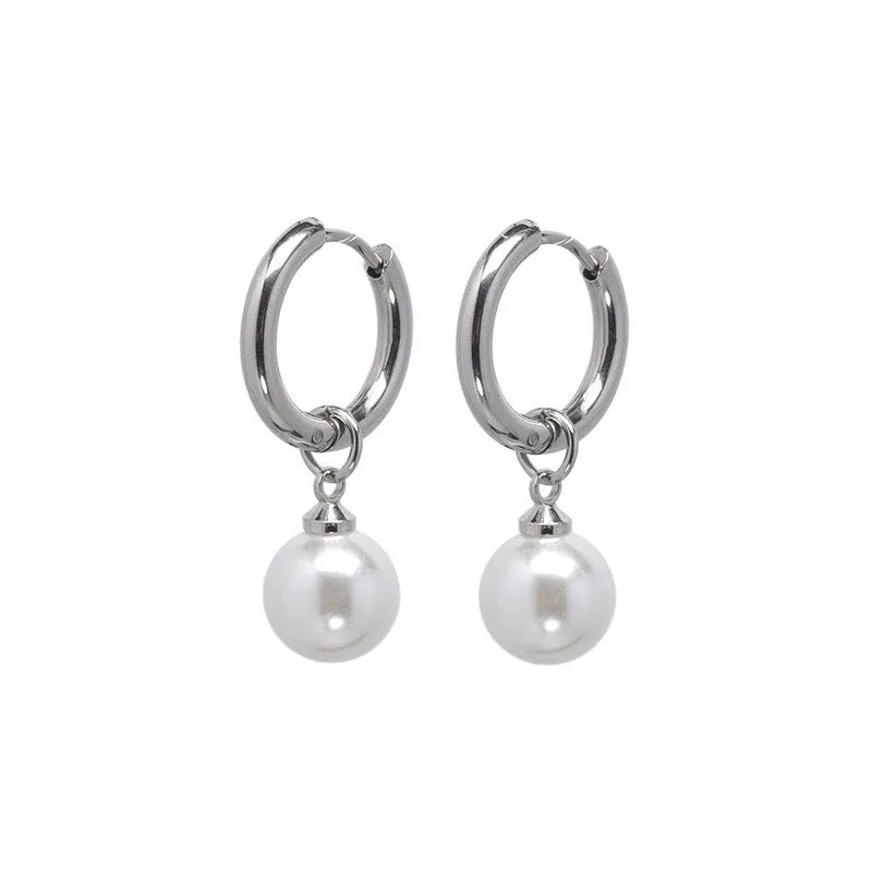 A pair of geometric pearl-coloured alloy earrings with titanium steel posts on a white background.
