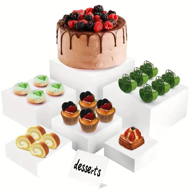 White plastic cube-shaped dessert display stands arranged on countertop for cake presentation