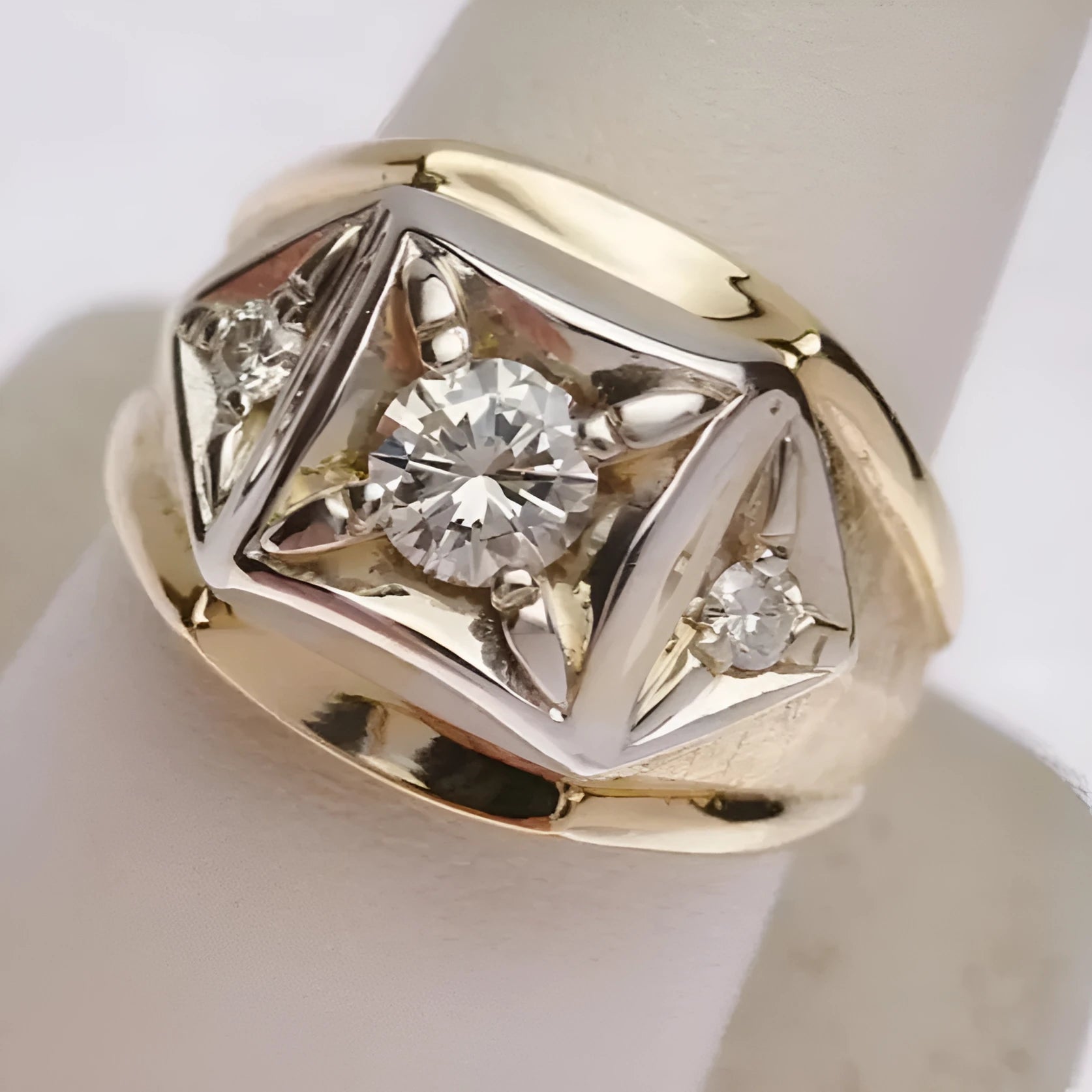 Gold-coloured geometric hollow copper couple rings showing chamfered square pattern detail