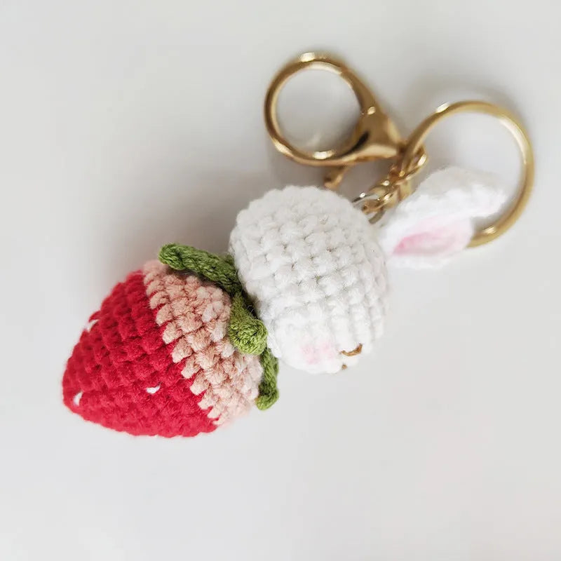Hand-woven white wire rabbit pendant with strawberry pattern and attached key chain