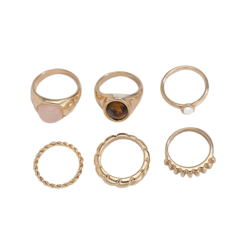 Six irregular geometric alloy rings in light gold electroplated finish arranged as set