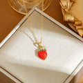 Women's titanium steel necklace with small red cherry, strawberry, and pepper charms on O-ring chain.