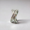 Silver cross ring with micro-inlaid zircon stones and geometric heart design on hand