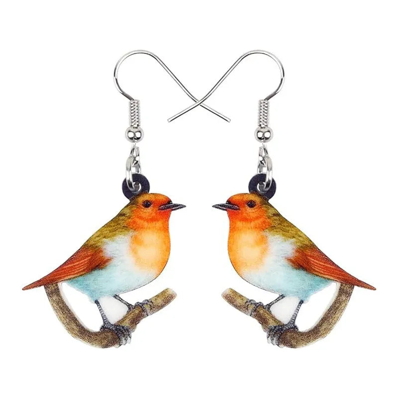 Close-up of women's acrylic earrings with a blue titmouse bird pendant and geometric snake motif design.