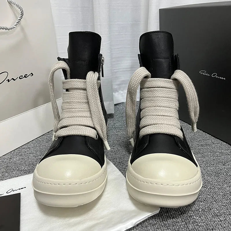 Genuine leather high-top sneakers in black with side zipper and rubber sole.