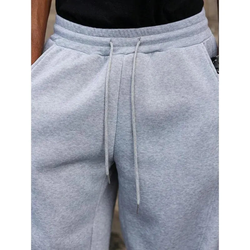 Men's high-waisted straight-leg cropped trousers in a neutral colour on a model